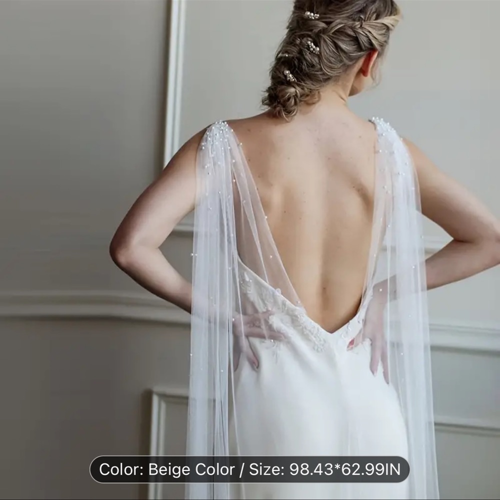 Beautiful chapel length cape veil with pearl detailing on the top! New- unworn